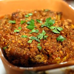 Eggplant stuffed with lamb mince and pine nuts with a rich tomato and pomegranate sauce.