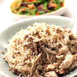 A chicken rice pilaf with lamb, roasted pine nuts almonds, flaked chicken scattered through.